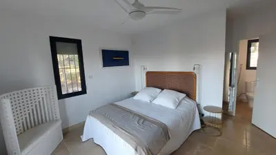a bedroom with a bed with white sheets and a window at Appartement entier Vue sur PAYS D Aix in Aix-en-Provence