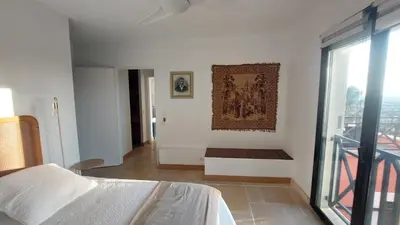 a bedroom with a bed and a painting on the wall at Appartement entier Vue sur PAYS D Aix in Aix-en-Provence