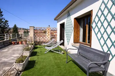 a yard with lawn chairs and a house at Chez Malé - Joli appartement cosy avec grande terrasse et parking proche Parc Jourdan & Centre ville historique in Aix-en-Provence