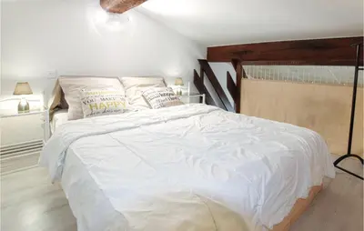 a bedroom with a large bed with white sheets and pillows at Beautiful Home In Carpentras in Carpentras