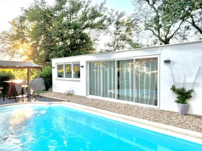 a swimming pool in front of a house at Échappée Mistral - Détente Jacuzzi privé & Brasero in Eyragues