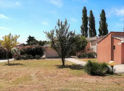 a house with a tree in a yard at chez bruno et marie jo in Saint-Saturnin-lès-Avignon