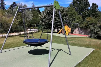an empty playground with a swing in a park at chez bruno et marie jo in Saint-Saturnin-lès-Avignon