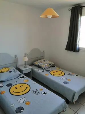 two beds with hello kitty pillows in a room at chez bruno et marie jo in Saint-Saturnin-lès-Avignon
