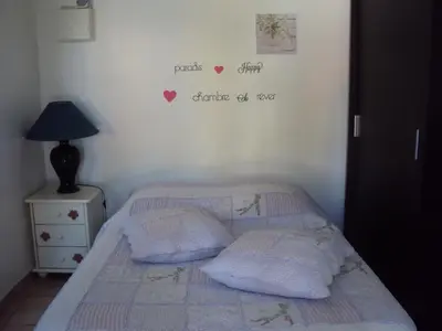 a bedroom with a bed with hearts on the wall at La Douloire in Pernes-les-Fontaines