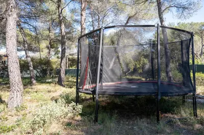 a trampoline in a glass enclosure in a field at Villa climatisée avec vue en pleine pinède aixoise in Saint-Marc-Jaumegarde