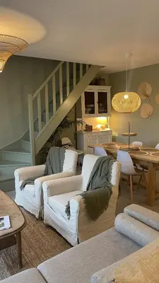 a living room with a wooden table and chairs at Maison Le Clos Du Moulin 3 - Climatisée, jardin & parking gratuit - 3 chambres doubles - 10 min Avignon in Entraigues-sur-la-Sorgue