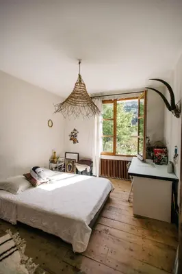 a bedroom with a bed and a desk and a window at Hidden gem with panoramic views in Fontaine-de-Vaucluse