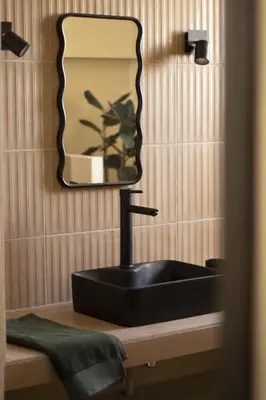 a bathroom with a black sink and a mirror at Casëto Luberon in Apt