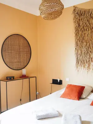 a bedroom with a bed and two baskets on the wall at Casëto Luberon in Apt