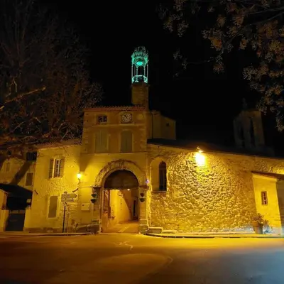a building with a clock tower on top of it at night at Mon Ventoux in Modène