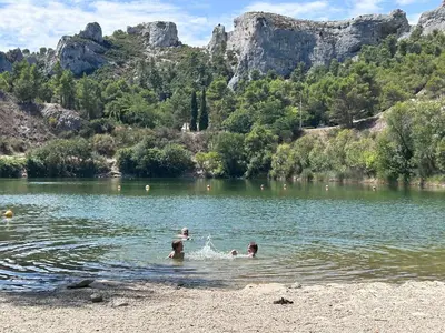 a group of people swimming in a lake at La Bégude des Alpilles in Orgon