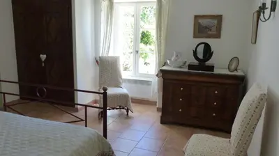 a bedroom with a bed and a dresser and a window at Luberon - Mas du Grand Saint Julien in Rustrel