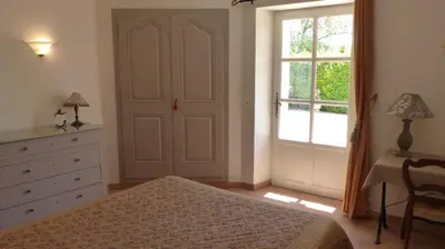 a bedroom with a bed and a dresser and a window at Luberon - Mas du Grand Saint Julien in Rustrel