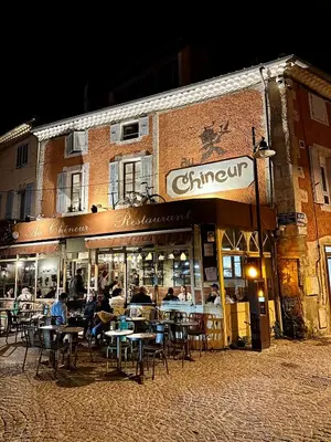 a group of people sitting at tables outside of a restaurant at Lou Paseo : Appartement Brocante centre historique in LʼIsle-sur-la-Sorgue