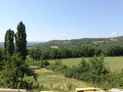 a view of a field with trees in the distance at La Grande Bouisse gites avec piscine dans le Luberon, Provence in Céreste