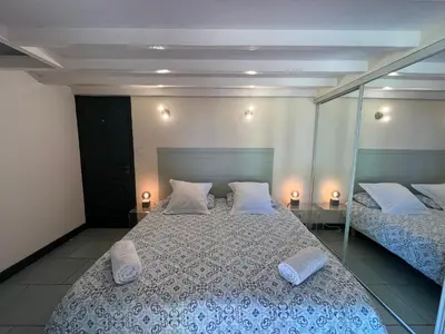 a bedroom with a large bed with mirrors on it at Petite Toscane Villa close to Aix en Provence in Ventabren
