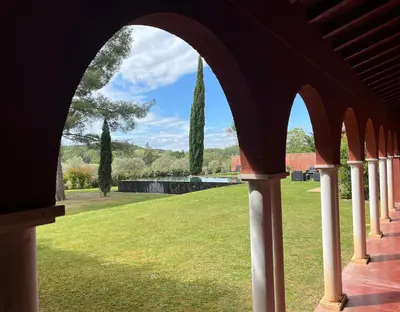an archway of a building with a view of a park at Petite Toscane Villa close to Aix en Provence in Ventabren