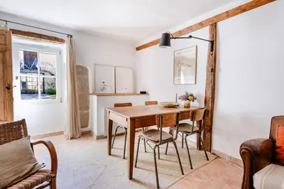 a dining room with a wooden table and chairs at Chez Prunelle in Flassan