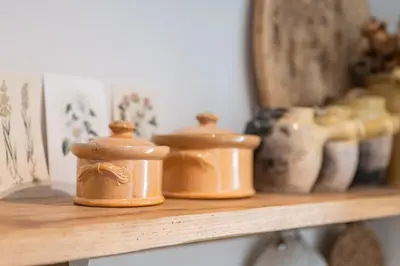 a shelf with some brown containers on it at Chez Prunelle in Flassan