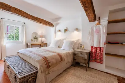 a bedroom with a large bed and a window at Chez Prunelle in Flassan
