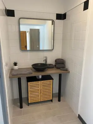 a bathroom with a sink and a mirror at Résidence Soleado Maison jumelée à 800m du centre ville de Bédoin in Bédoin