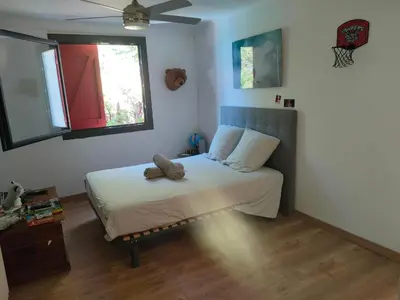 a bedroom with a bed with a teddy bear on it at Bastide vue exceptionnelle in Aix-en-Provence