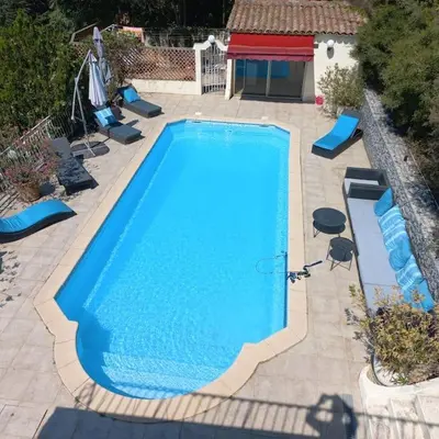 a large blue swimming pool in a yard at Bastide vue exceptionnelle in Aix-en-Provence