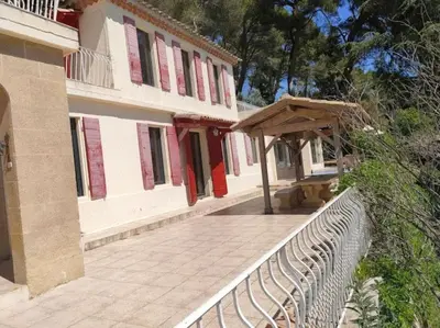 a building with a fence and a bench in front of it at Bastide vue exceptionnelle in Aix-en-Provence