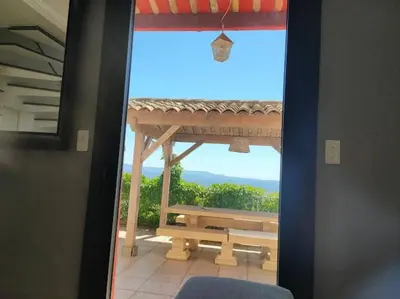 a door to a balcony with a table and a view at Bastide vue exceptionnelle in Aix-en-Provence