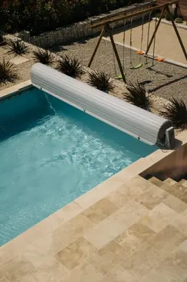 a swimming pool with a white tube in the water at Villa Moka - private pool in Saumane-de-Vaucluse