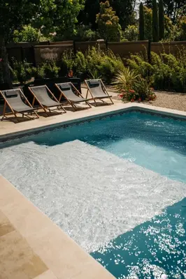 a swimming pool with lounge chairs and a swimming pool at Villa Moka - private pool in Saumane-de-Vaucluse