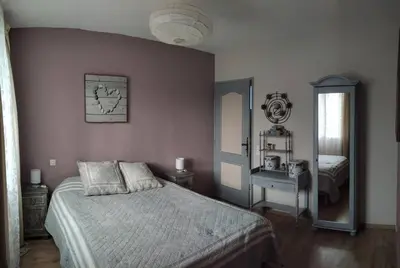 a bedroom with a bed and a mirror at Le Mas des Cigales avec parc et grande piscine in Velleron