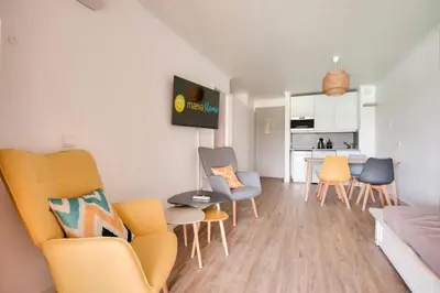 a living room with chairs and a dining room at Village Pont Royal en Provence - maeva Home - Appartement cosy et climatisé 2 pièces 4 personnes - Sélection - super Home MAE-2154 in Mallemort
