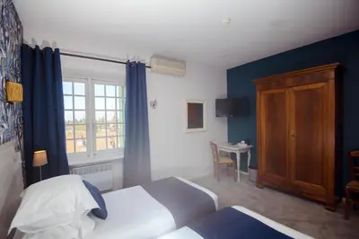 a hotel room with a bed and a window at Demeures et Châteaux Hôtel L'Hermitage in Pernes-les-Fontaines