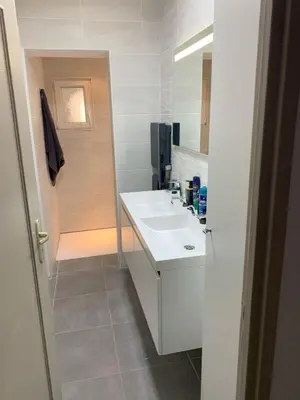 a white bathroom with a sink and a shower at Villa Les Cigales Velaux in Velaux