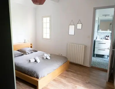 a bedroom with a bed with two stuffed animals on it at Spacieux T3 * centre ville * sans vis à vis in Aix-en-Provence