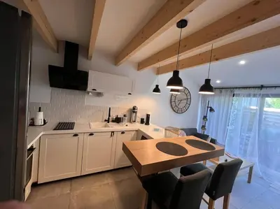 a kitchen with a wooden table and a dining room at Cocon Classé 3 Etoiles - Love et Détente - SPA in Carpentras
