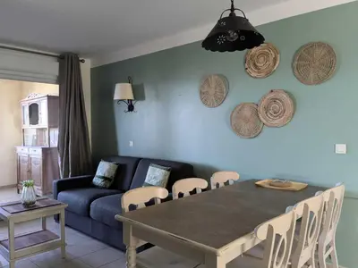 a living room with a table and a couch at Les Coteaux de Pont Royal en Provence - maeva Home - Appartement 3 pièces 6 personnes - Prestige MAE-2554 in Mallemort