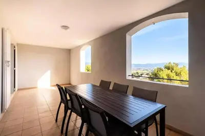a dining room with a table and chairs and a window at Les Coteaux de Pont Royal en Provence - maeva Home - Appartement 3 pièces 6 personnes - Prestige MAE-2554 in Mallemort