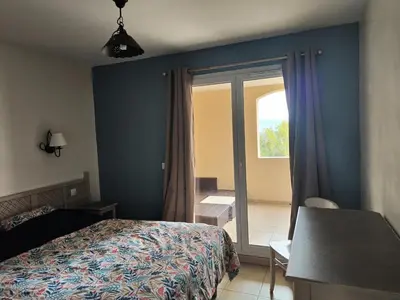a bedroom with a bed and a sliding glass door at Les Coteaux de Pont Royal en Provence - maeva Home - Appartement 3 pièces 6 personnes - Prestige MAE-2554 in Mallemort