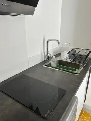 a kitchen counter with a sink and aaucet at Maison, Jardin, piscine parking près d'Aix Centre in Venelles