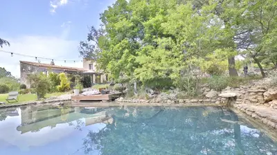 a large pool of water in a yard at Coin de paradis en Provence in Sault-de-Vaucluse