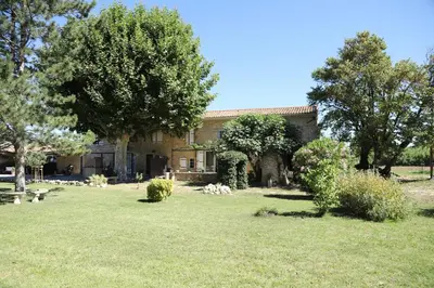 a house with trees and a grass yard at Duplex de charme au coeur de la Provence. in Pertuis