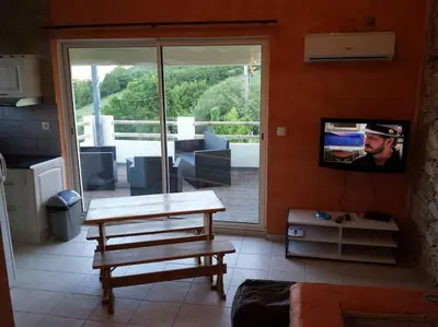a living room with a table and a tv at Location provence ventoux sault in Sault-de-Vaucluse