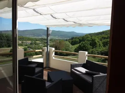 a balcony with chairs and a view of the mountains at Location provence ventoux sault in Sault-de-Vaucluse