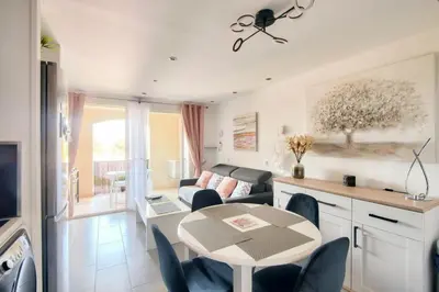a living room with a table and a couch at Village Pont Royal en Provence - maeva Home - Appartement cosy et climatisé 2 pièces 4 personnes - Prestige - super Home MAE-2164 in Mallemort