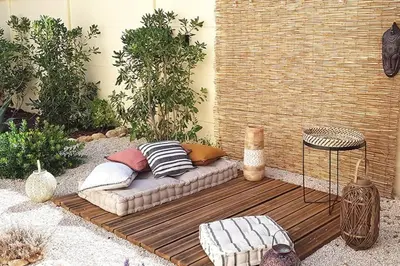 a couch sitting on a wooden deck in a garden at Villa tout confort, piscine - Au pied du VENTOUX in Saint-Didier