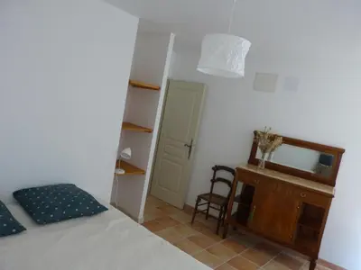 a bedroom with a bed and a dresser and a mirror at Gite du domaine Saint-Marc, entre Ventoux et dentelles de Montmirail in Caromb