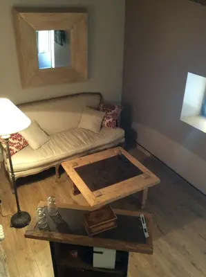 a living room with a couch and a table at La Maiz in Maubec